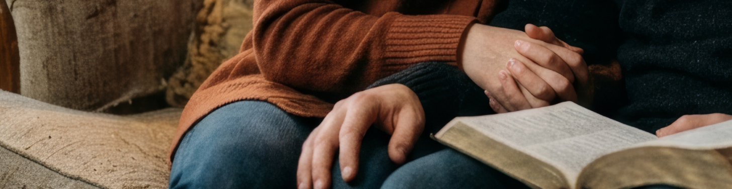 Couple holding hands with open book